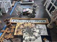 Overall lot showing fleur-de-lis statue, metal medallion, crosses, French Quarter sign