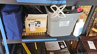 Shelf with MountTEK box and bin of rollers/brushes
