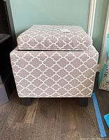 Front view of gray geometric storage ottoman
