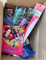 Box with Spirit hair extensions, Ed Hardy items, blue accessory pouch visible