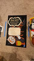 Overview of doormat and three signs arranged on floor