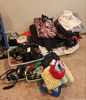Pile showing jackets, bags, shoes, blanket and plush toy