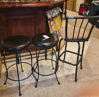 Front view of all three stools at bar
