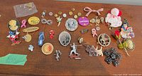 Full lot on dresser showing all pins and brooches
