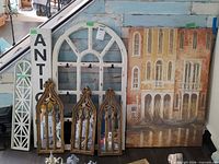Overall lot showing all five wall décor pieces leaning against wall
