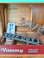 All items grouped in cabinet: crate, backboard, three signs