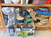 Overall view of faux-rock cave, heat lamp box, dog bed, storage bin and accessories