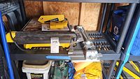 Wet saw, manual rail cutter and accessories on shelving