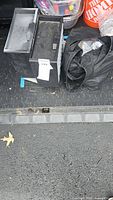 Black plastic organizer, compartment case and bag visible