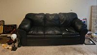 Front view of black faux leather 3-seater sofa