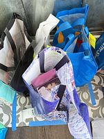 Reusable shopping bags containing multiple CD jewel cases; view shows quantity and storage.