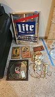 Group shot with Lite Beer mirror, Miller High Life mirror, three wooden signs, Schlitz lamp