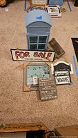 Overview of lot with blue cabinet, signs, shelf, memory frame