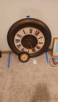 Both wall clocks side by side for scale