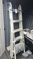 Werner articulating ladder folded with step stool in front
