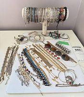 Overall lot on T-bar stand and board displaying variety of bracelets
