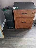 Front view of black umbrella stand cabinet beside another piece