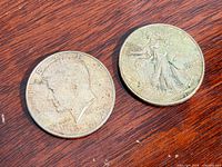 Both half dollars obverse sides on wood surface