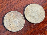 Both Canadian half dollars obverse side visible