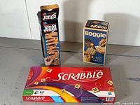 Front view of all three boxed games: Jenga, Boggle, Scrabble