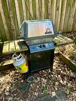 Full view of Broil King propane grill with propane tank attached