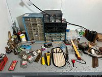Overall view of workbench top showing organizers, tools and hardware