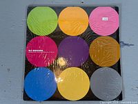 Front cover of DJ Design LP showing nine colored circles