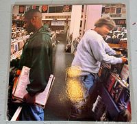 Front of album jacket with two shoppers in record store