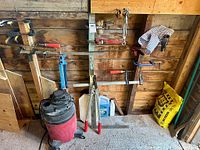 Overall wall with clamps, wrenches, loppers, levels, shop vac and mortar bag