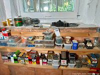 Wide view of shelf with numerous plastic bins and boxes of fasteners
