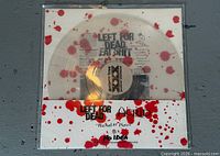 Front view of clear red-splatter vinyl inside sleeve showing labels and artwork