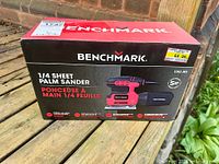 Full front view of sealed Benchmark palm sander box