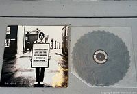 Front sleeve of The Verve record beside saw-blade vinyl in sleeve