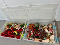 Two clear bins open showing assorted ornaments