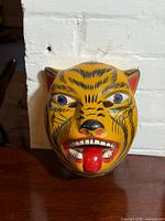 Front view of yellow tiger mask with red tongue