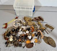 Full lot spread showing mixed hardware pieces and storage bin