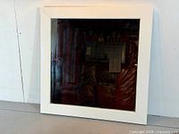 Front view of square white metal framed mirror