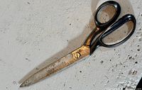 Full view of Wiss Inlaid 22 tailor shears showing black handles and blade condition