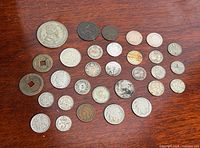 All coins laid out on wooden surface, full lot overview