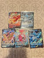 All five Pokémon V cards laid out on surface