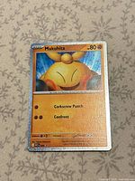 Front of Makuhita holo card showing artwork, stats, holo border