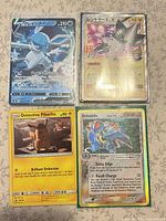 Group shot of four Pokémon cards in sleeves