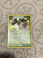 Front of Seedot EX Deoxys holographic card showing artwork, text and wear