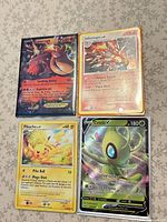 All four Pokémon cards arranged on tabletop