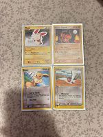 All four Pokémon cards laid out 2×2 showing fronts