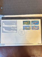Full view of first day cover showing envelope, illustrations and four stamps