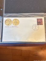 Full view of first day cover in sleeve showing stamp, cancel and medallion graphics