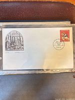 Full view of first day cover inside protective sleeve showing cachet, stamp and cancel