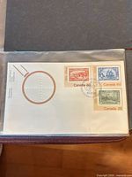 Full view of the first day cover in sleeve showing stamps and cancel