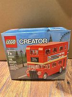 Front of sealed LEGO Creator 40220 box showing red double-decker bus image and piece count